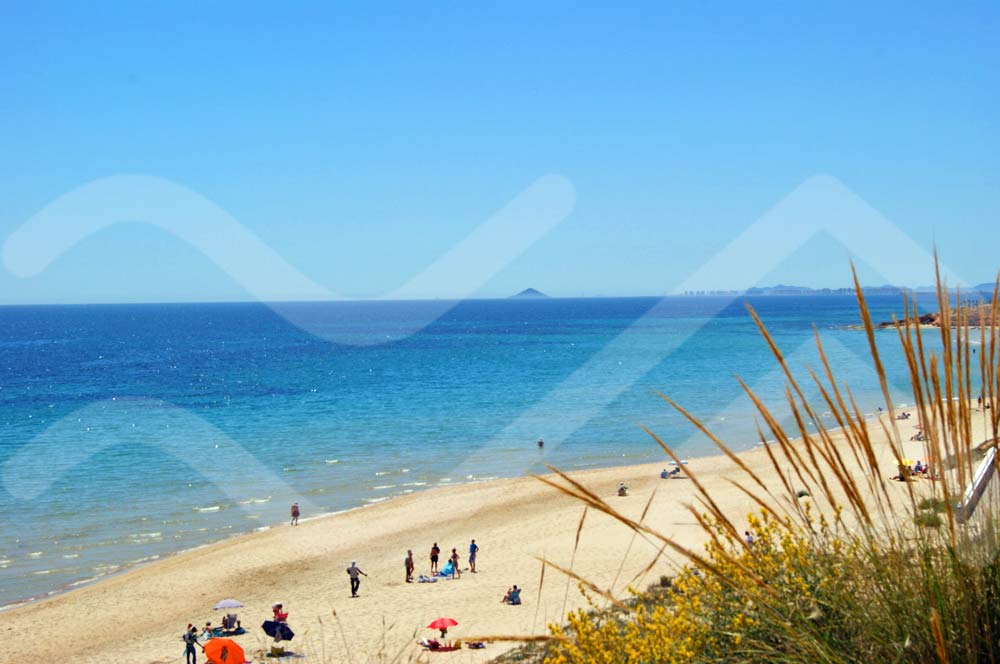 people enjoying the beach at torre de la horadada